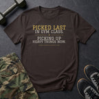 Picked Last in Gym Class. Picking Up Heavy Things Now. T-Shirt in Dark Chocolate